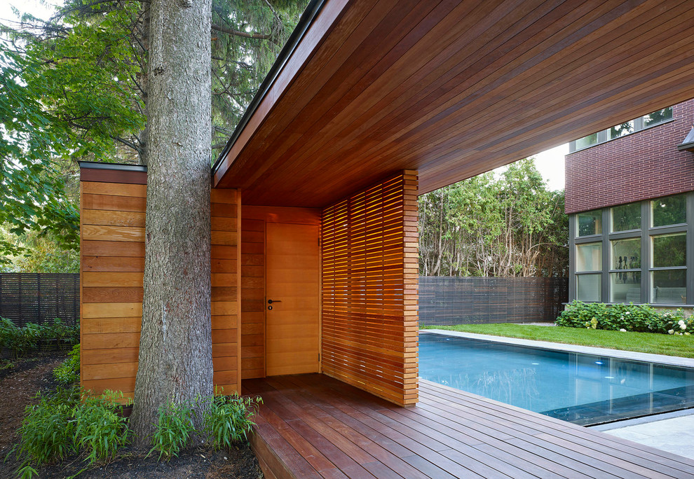 Inspiration for a large modern backyard concrete and rectangular aboveground pool house remodel in Toronto