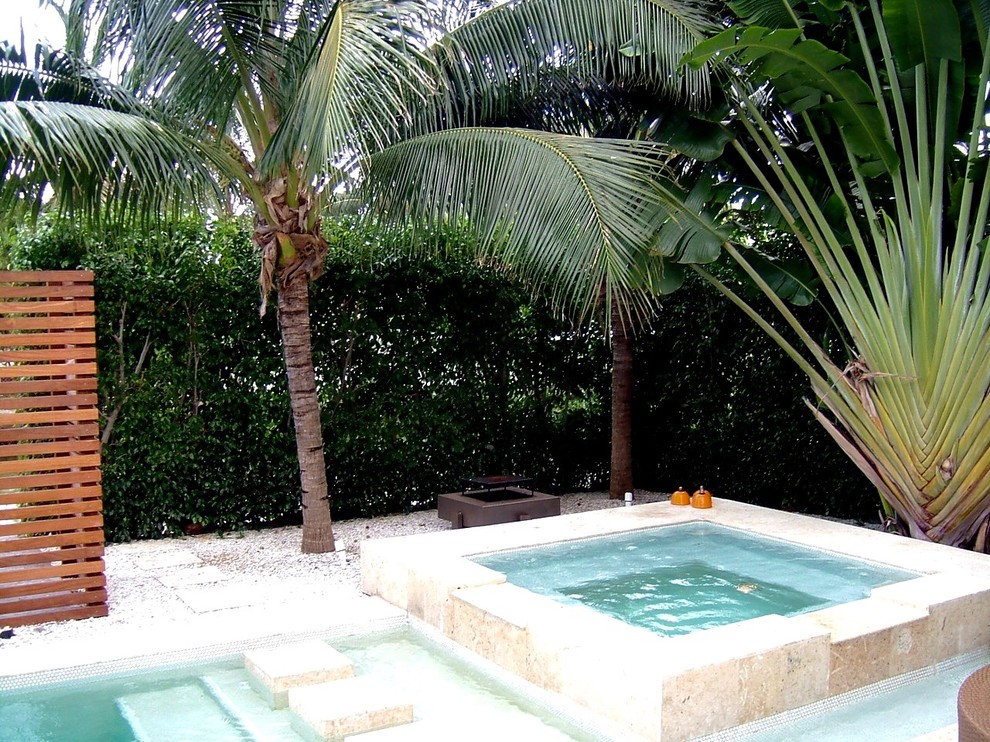 Example of a large island style tile and rectangular lap pool design in Miami