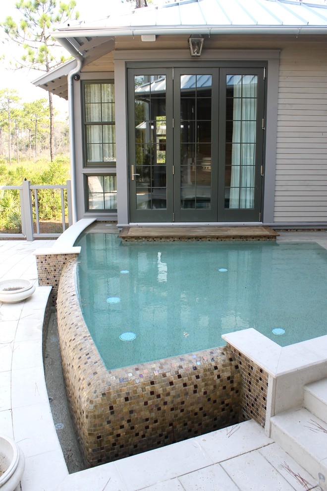 Large transitional backyard custom-shaped infinity pool fountain photo in Miami with decking
