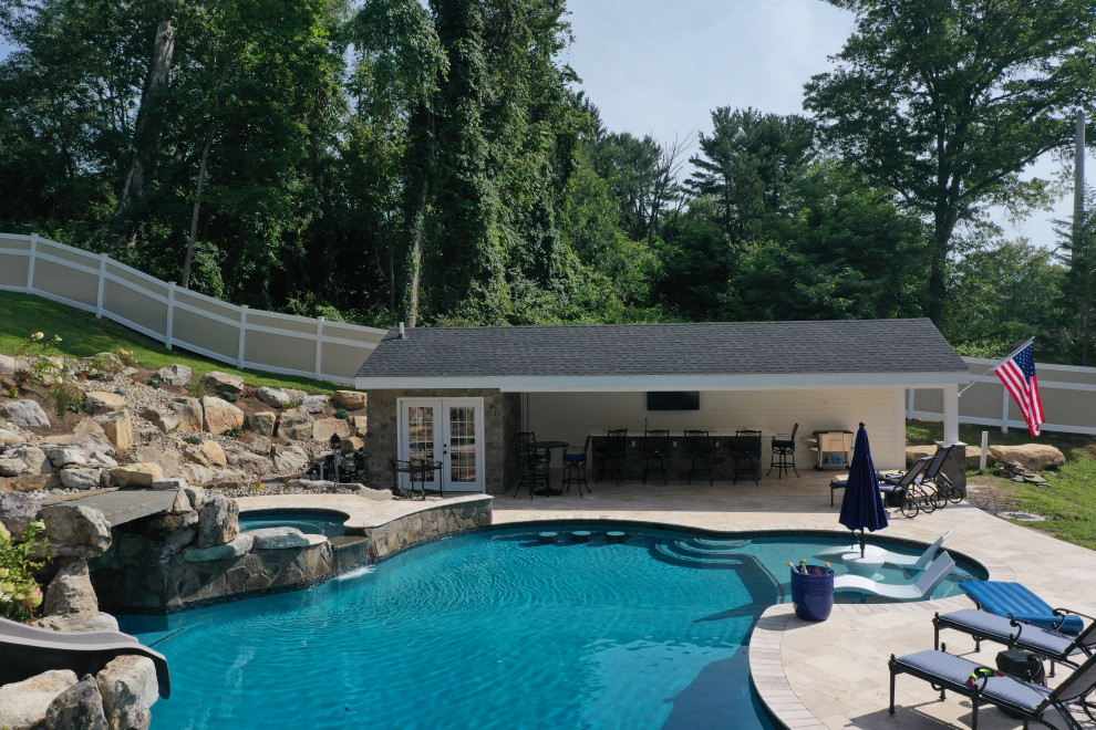 Inspiration for a medium sized rural back swimming pool in Philadelphia with natural stone paving.