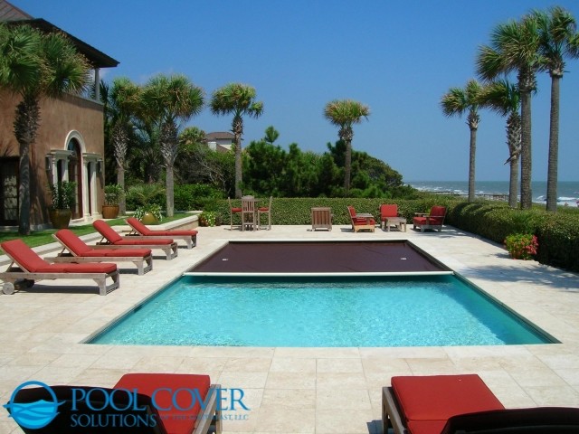Nautical back rectangular swimming pool in Charleston with natural stone paving.