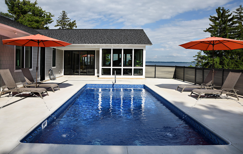 Example of a beach style backyard concrete and rectangular pool fountain design in Other