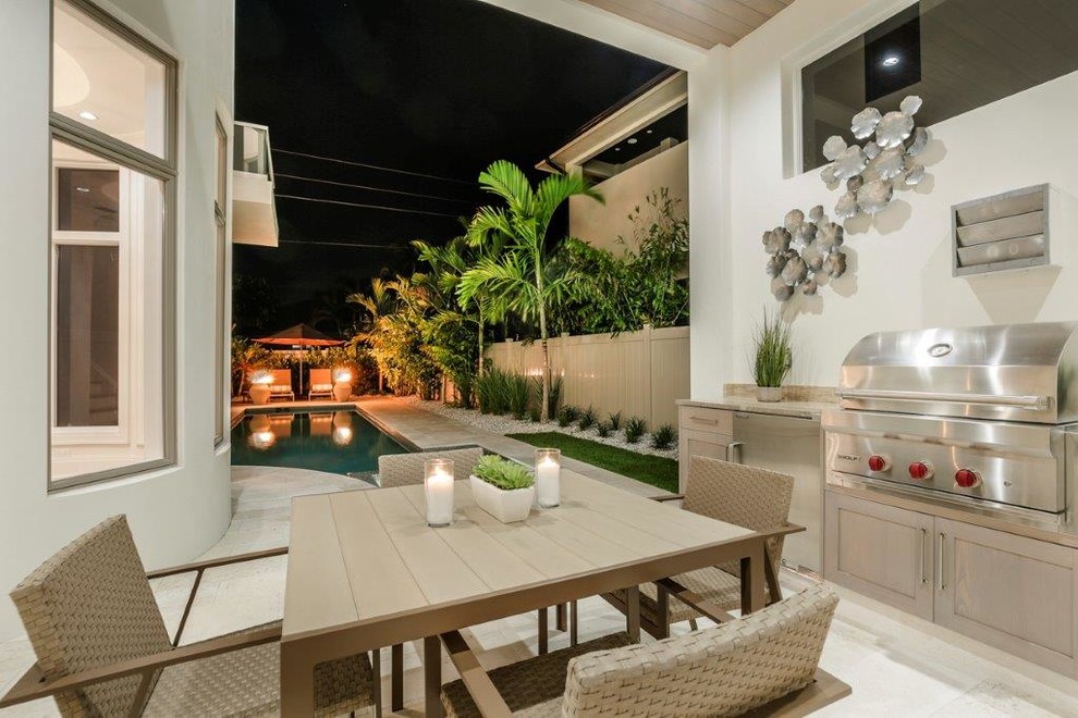 Large beach style backyard stone and rectangular lap hot tub photo in Miami