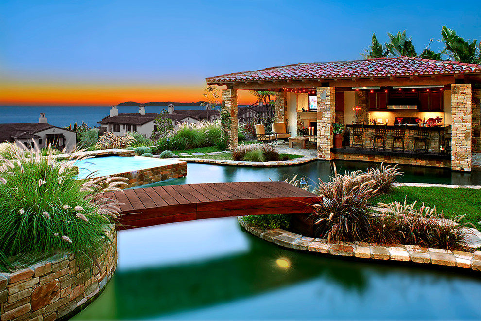 Inspiration for a mediterranean custom shaped swimming pool in Orange County with a bar area.