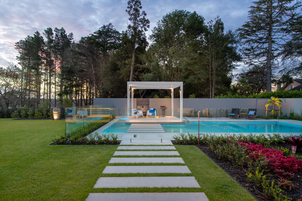 Pool - large contemporary backyard rectangular pool idea in Auckland