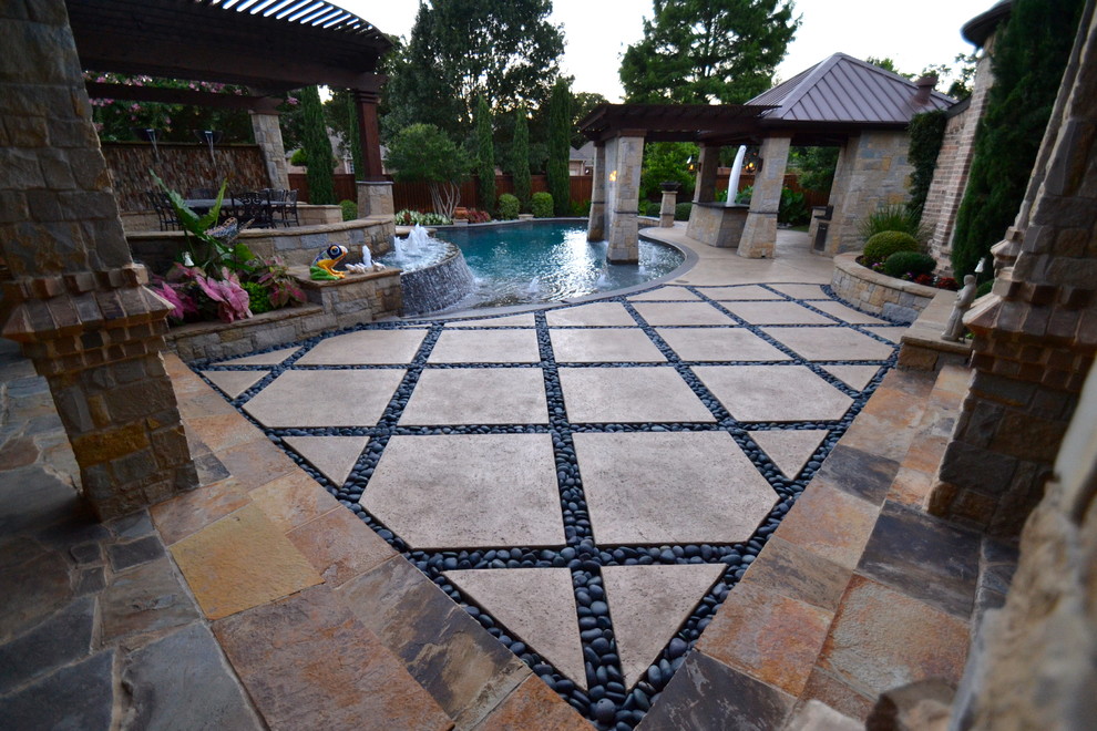 Design ideas for a large classic back custom shaped swimming pool in Dallas with stamped concrete and a water feature.