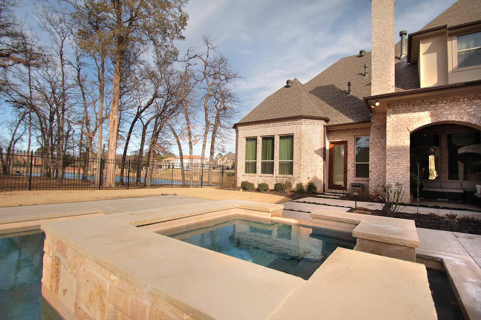 Example of a large classic backyard rectangular lap hot tub design in Dallas