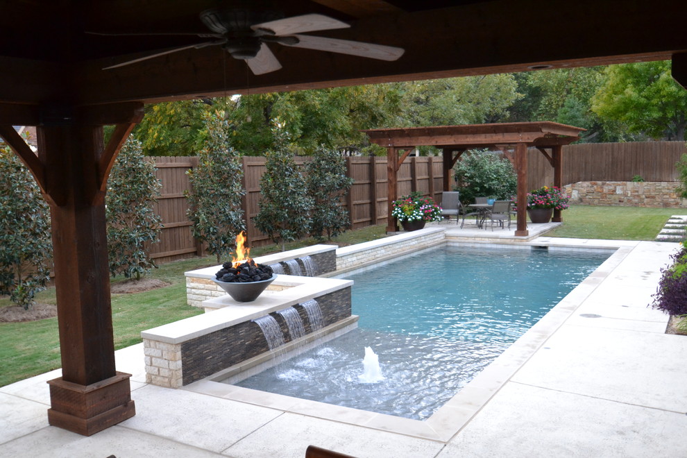 Example of a small trendy backyard rectangular pool fountain design in Dallas