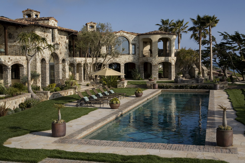 Inspiration for a mediterranean backyard rectangular pool remodel in Orange County