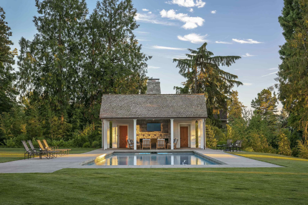 Example of a classic backyard concrete and rectangular lap pool house design in Portland