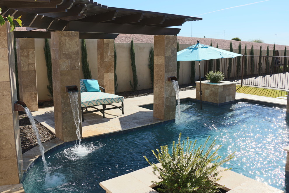 Example of a small minimalist courtyard stone and custom-shaped natural pool design in Phoenix