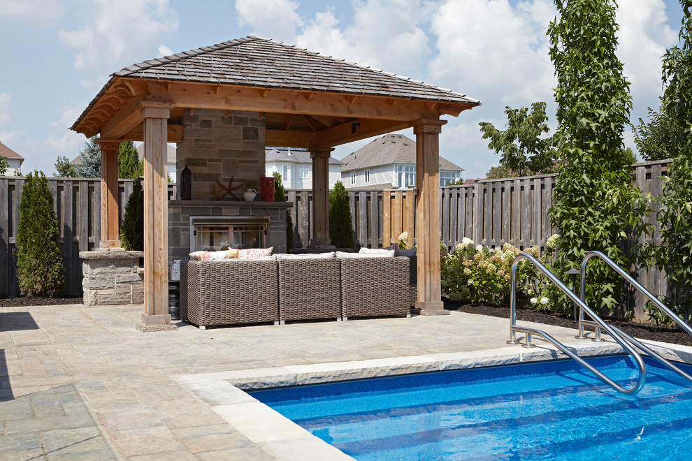 Imagen de piscina con fuente natural contemporánea pequeña rectangular en patio trasero con adoquines de ladrillo