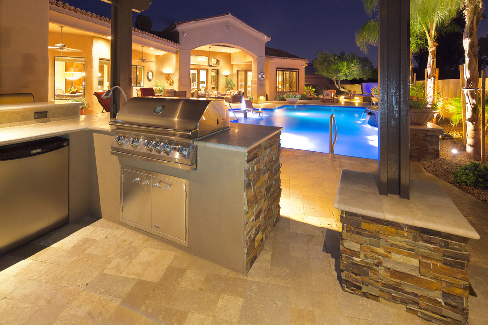Inspiration for a large mediterranean backyard stone and custom-shaped natural pool remodel in Phoenix