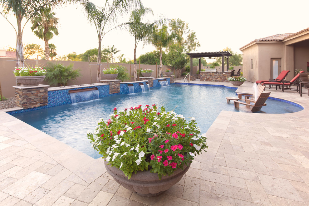 Large tuscan backyard stone and custom-shaped natural pool photo in Phoenix