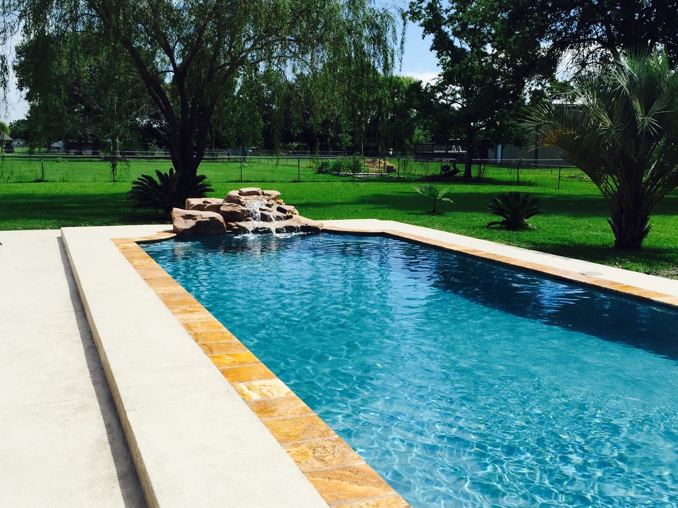 Foto di una piccola piscina naturale contemporanea rettangolare dietro casa con fontane e pedane