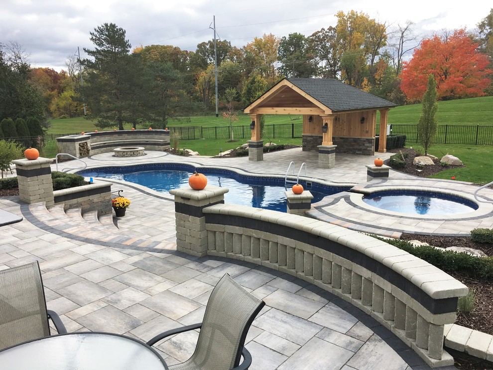Inspiration for a huge timeless backyard tile and custom-shaped aboveground hot tub remodel in Detroit