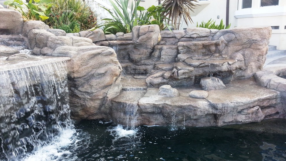 Example of a large trendy backyard stone and custom-shaped infinity pool fountain design in San Francisco