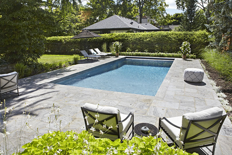 Pool - transitional backyard rectangular pool idea in Toronto