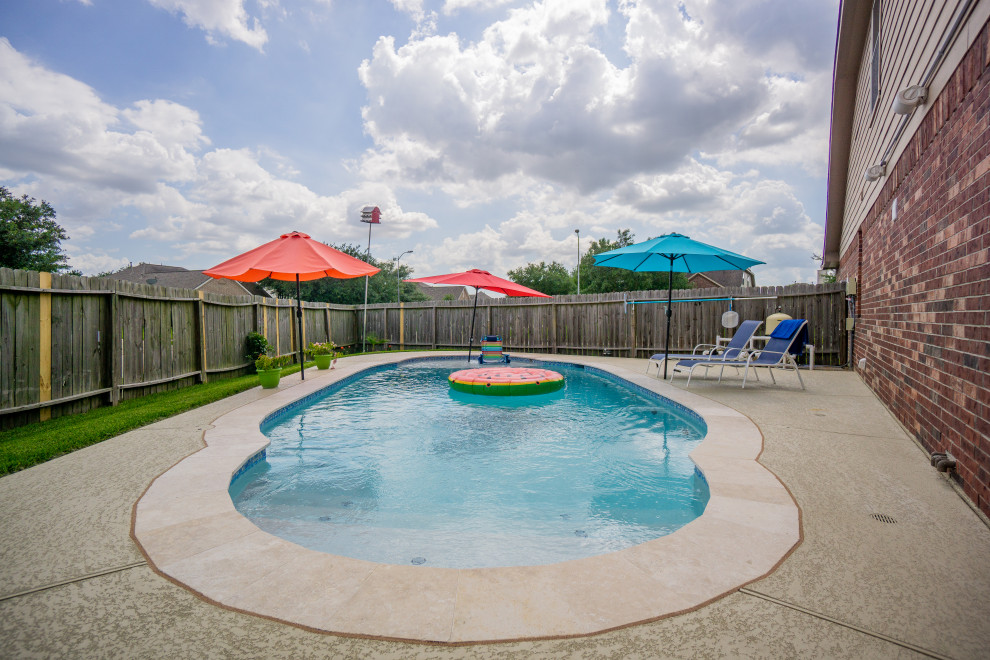 Design ideas for a medium sized world-inspired back custom shaped swimming pool in Houston with decking.