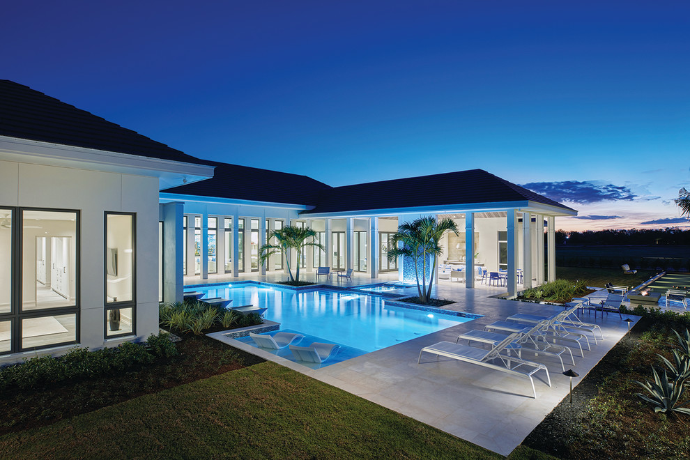 Photo of a large contemporary back rectangular swimming pool in Other with tiled flooring.