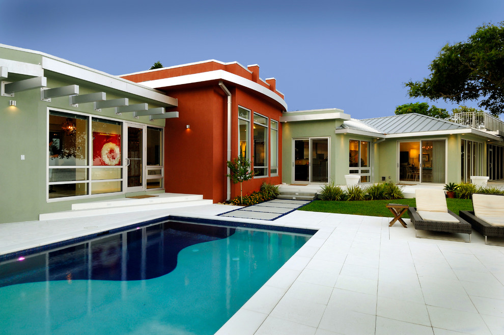 Inspiration for a mid-sized contemporary backyard stone and rectangular lap pool remodel in Tampa