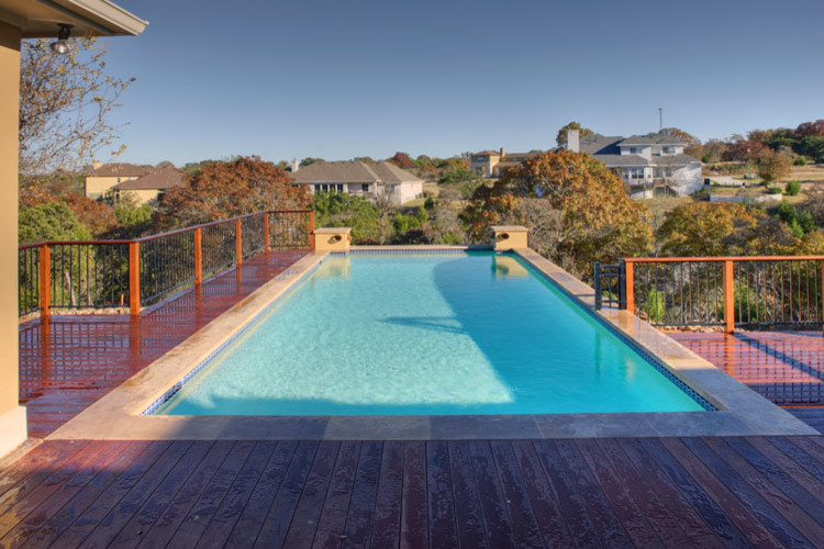 Inspiration for a large traditional back rectangular lengths swimming pool in Austin with decking.