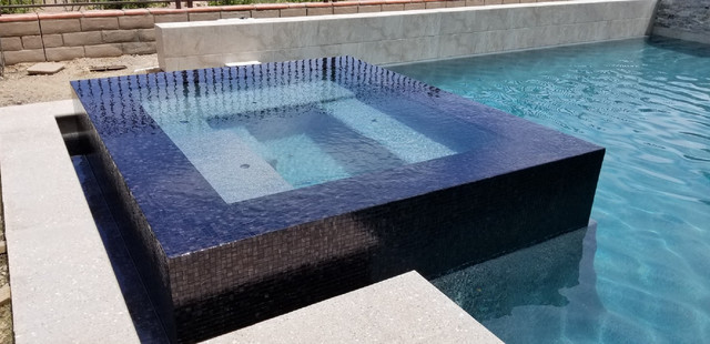 Contemporary pool and jacuzzi with black glass mosaic tile ...