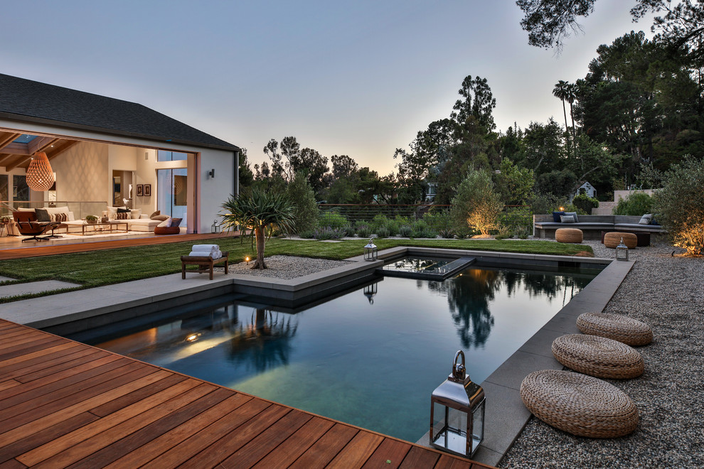 Pool - contemporary backyard custom-shaped lap pool idea in Los Angeles with decking
