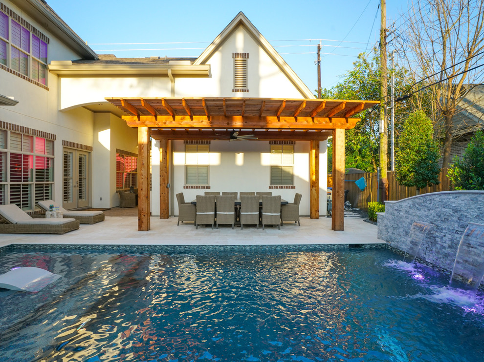This is an example of a small contemporary back rectangular natural swimming pool in Houston with a water feature.