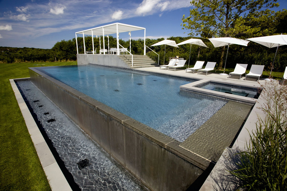 Design ideas for a contemporary rectangular infinity swimming pool in New York.