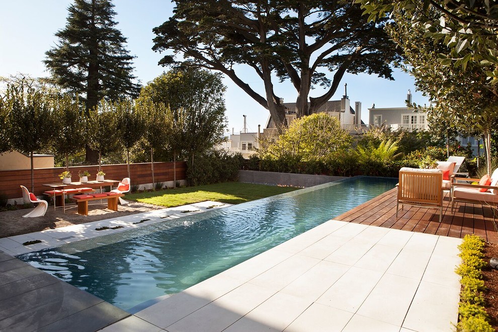 Trendy backyard rectangular lap pool photo in San Francisco with decking