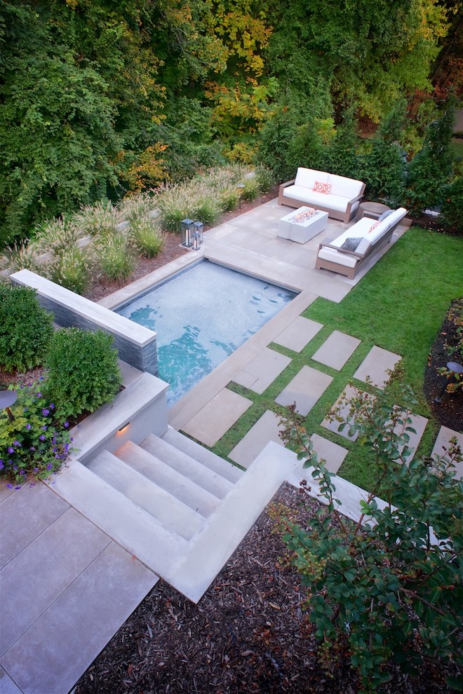 Inspiration for a medium sized contemporary back rectangular hot tub in New York with natural stone paving.