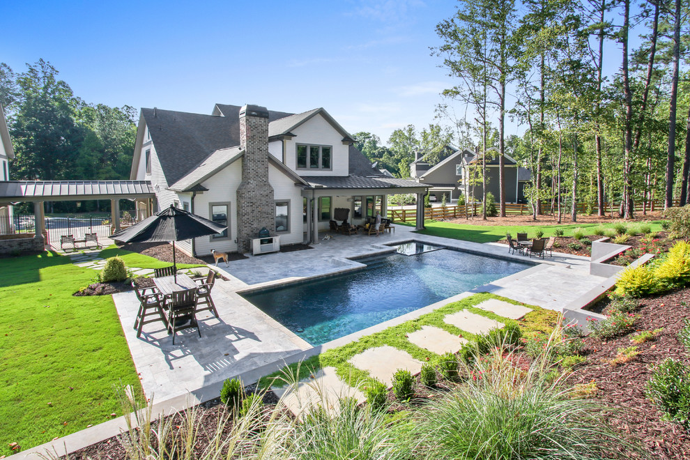 Example of a mid-sized trendy backyard stone and custom-shaped pool fountain design in Atlanta
