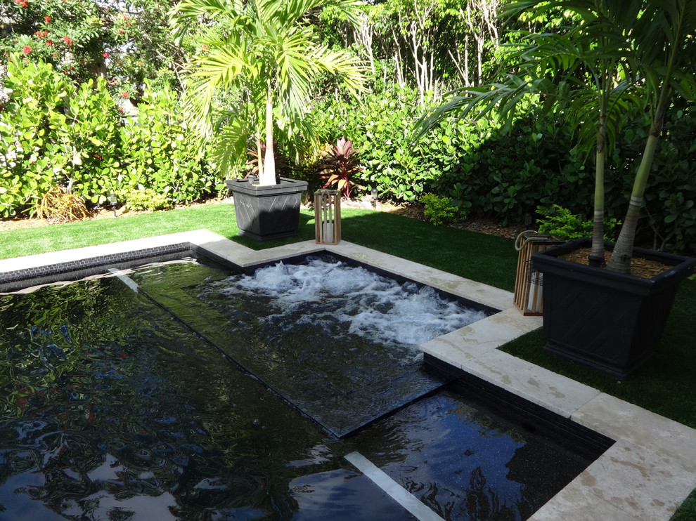 Small contemporary back rectangular natural hot tub in Miami.