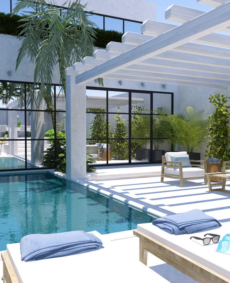 Ejemplo de piscina elevada contemporánea pequeña rectangular en patio trasero con suelo de hormigón estampado