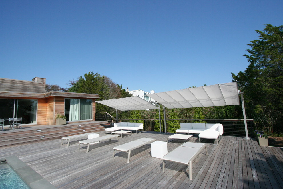 Immagine di una piscina contemporanea rettangolare di medie dimensioni e dietro casa con pedane