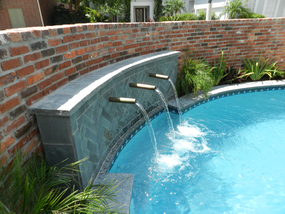 Example of a trendy backyard stamped concrete and custom-shaped pool fountain design in Houston