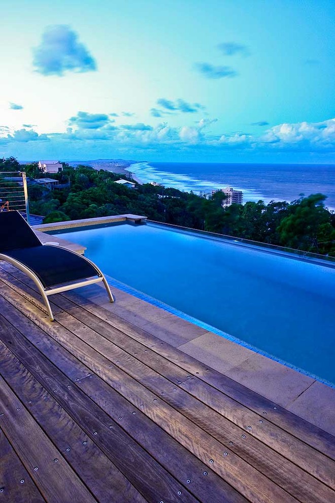 Inspiration for a large coastal backyard stone and rectangular lap pool remodel in Brisbane