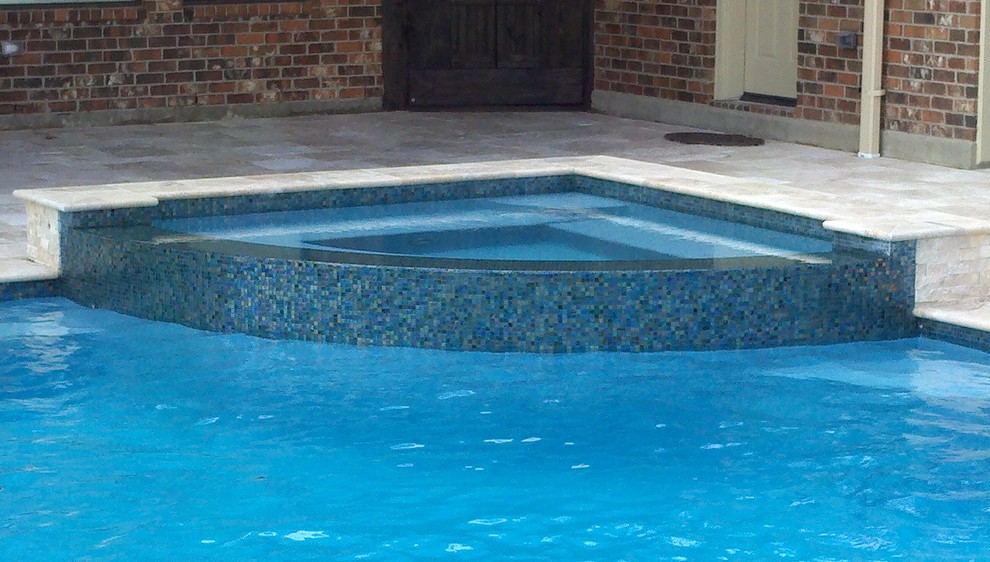 Example of a backyard custom-shaped hot tub design in Houston