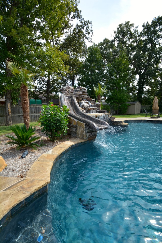 Example of a mid-sized mountain style backyard custom-shaped and stone lap water slide design in Little Rock