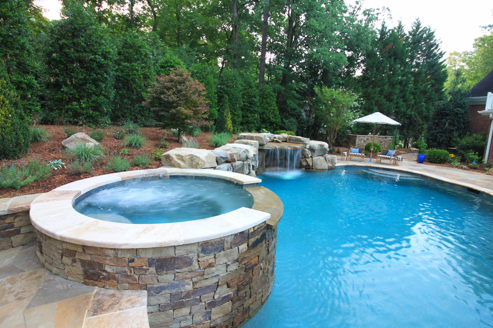 Inspiration for a rustic backyard stone and custom-shaped lap hot tub remodel in Raleigh