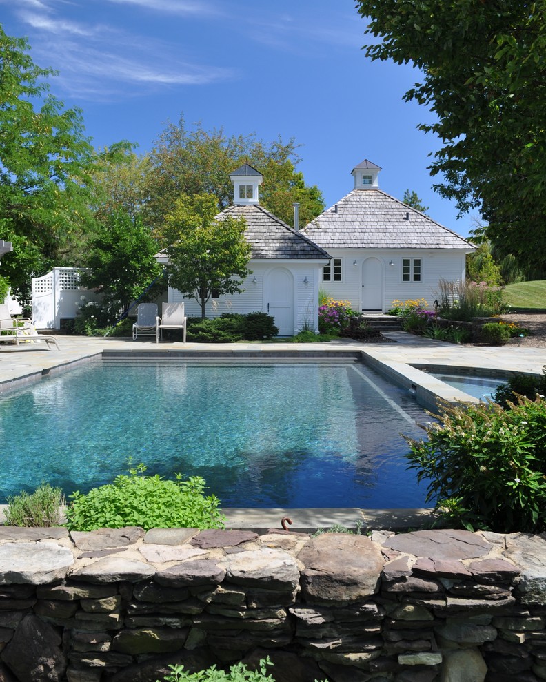Traditional swimming pool in Chicago with natural stone paving.