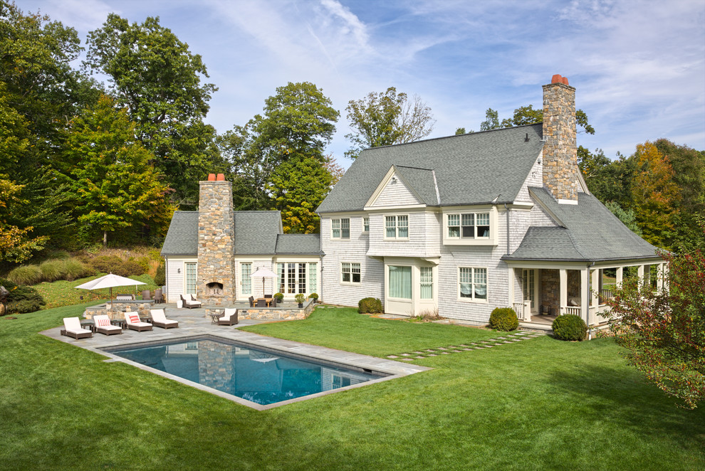 Inspiration for a large timeless backyard rectangular and stone lap pool remodel in New York