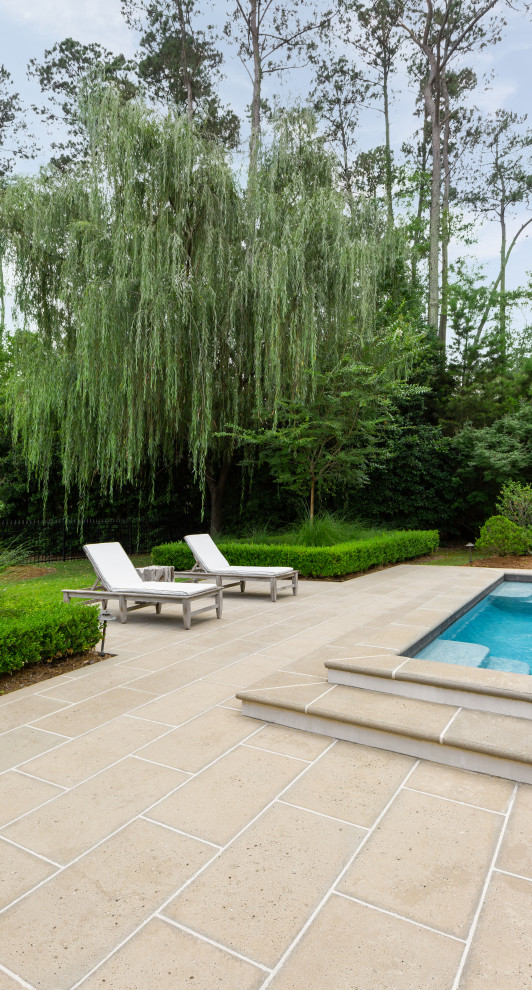 Example of a trendy concrete paver pool design in New Orleans