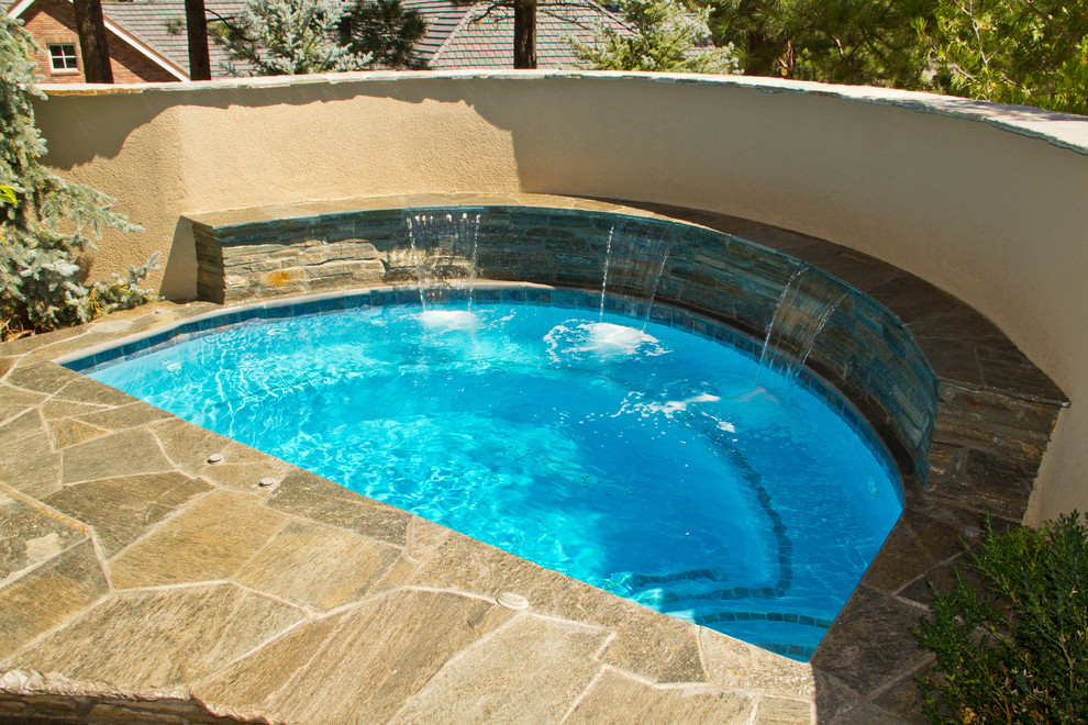 Example of a small classic backyard custom-shaped natural hot tub design in Other
