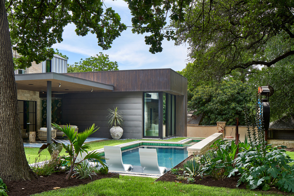 Immagine di una piscina monocorsia design rettangolare dietro casa con una vasca idromassaggio