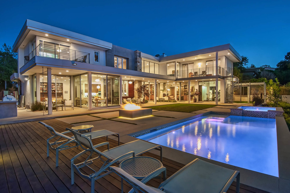This is an example of a contemporary back rectangular lengths swimming pool in Los Angeles.