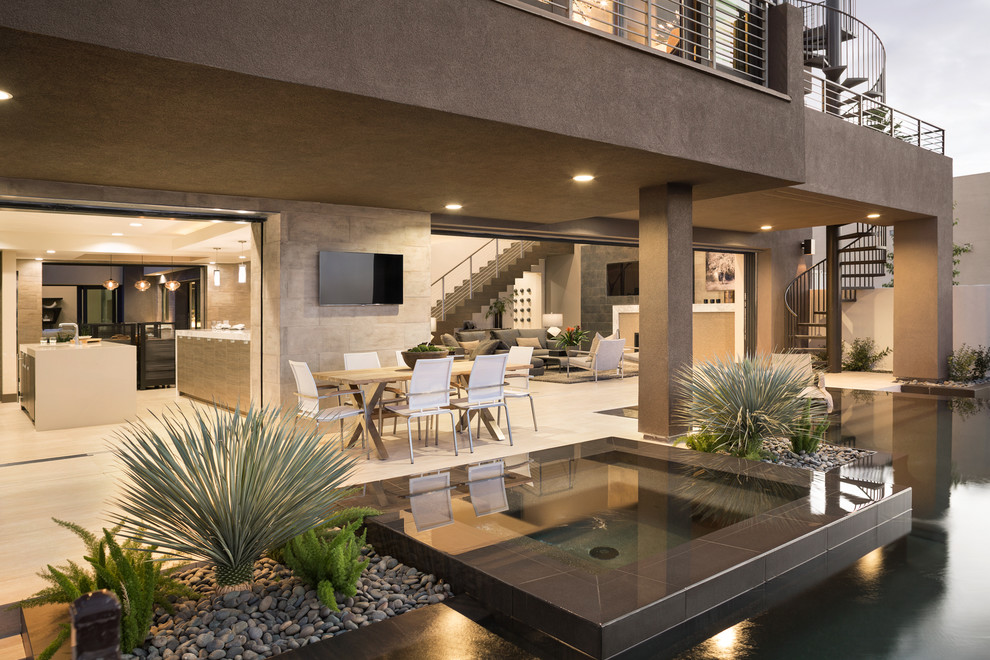 Hot tub - large contemporary backyard concrete and custom-shaped infinity hot tub idea in Las Vegas
