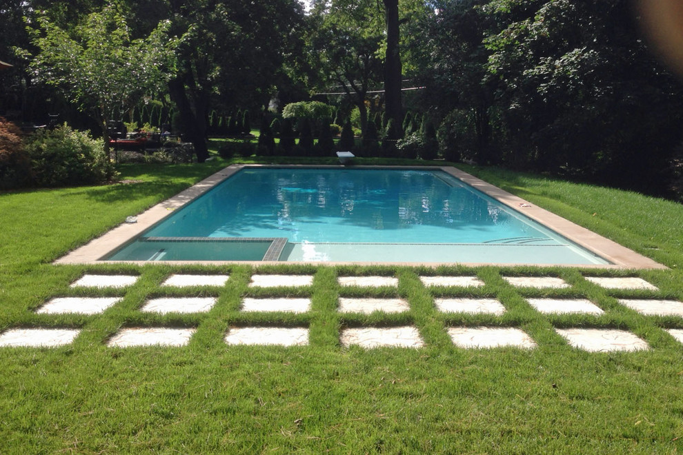 Modelo de piscinas y jacuzzis modernos de tamaño medio rectangulares en patio trasero con suelo de baldosas