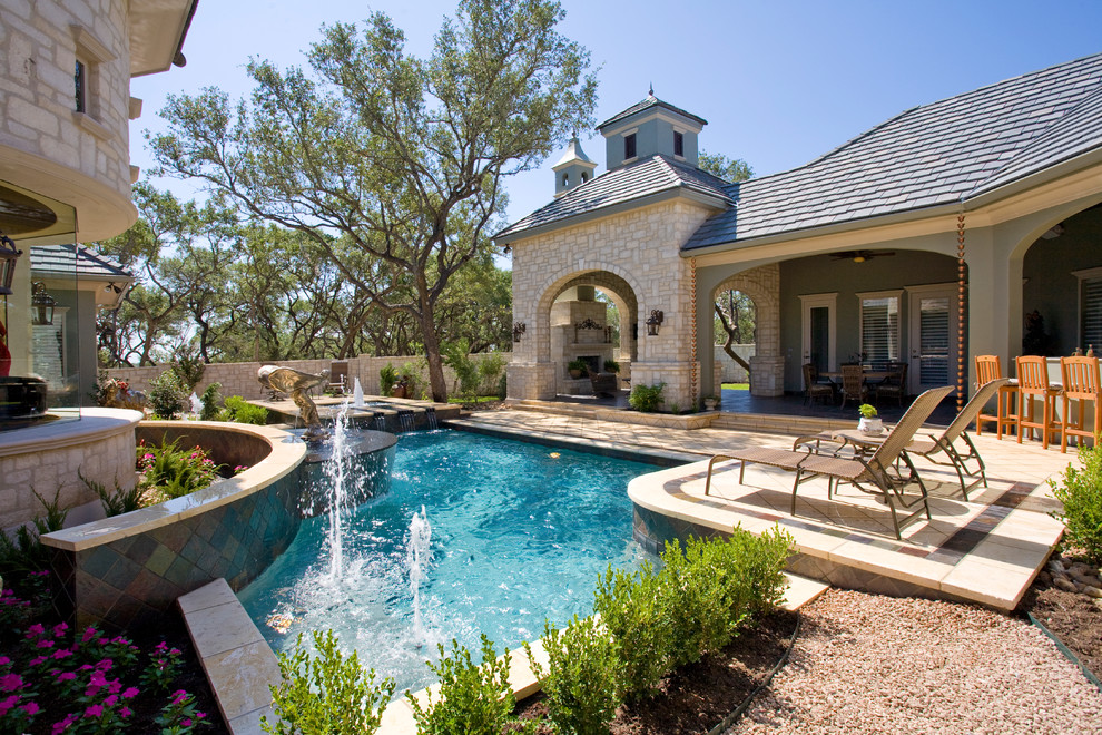 Example of a mid-sized classic courtyard custom-shaped pool fountain design in Austin with decking
